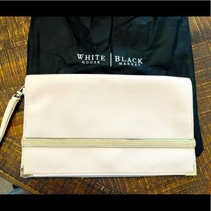 White House Black Market Pale Pink Clutch with suede trim and handle strap.